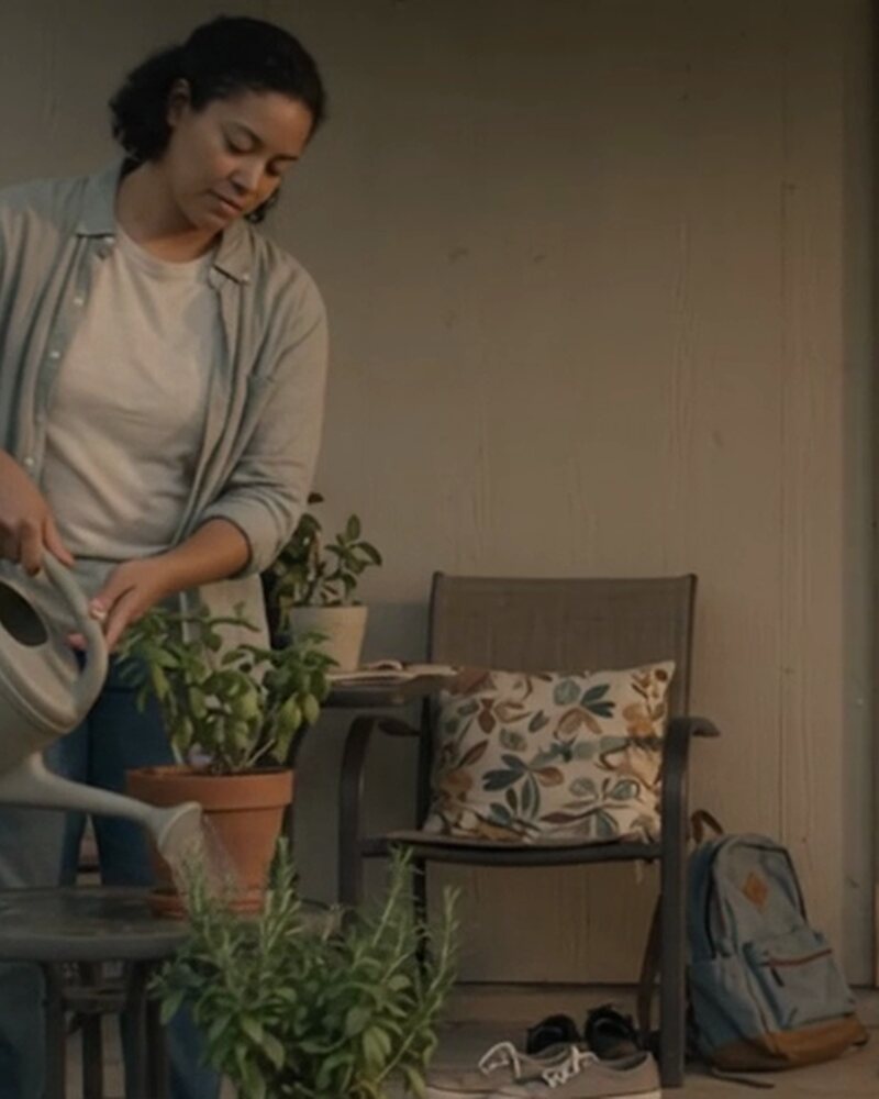 A family sharing an ordinary evening on the porch of a lived-in Texas home