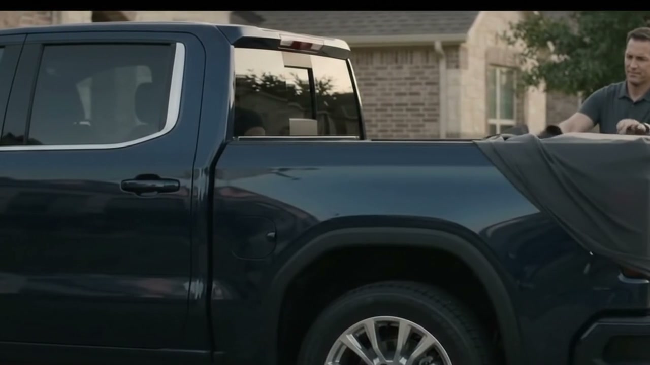 A new vehicle is revealed before a completed handshake and a physical key starts the dashboard.